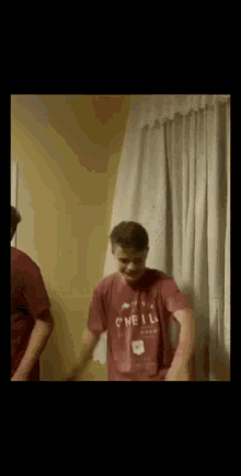 a man wearing a red shirt that says o'neill is dancing