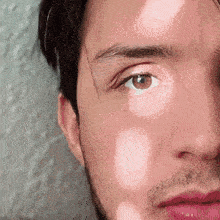 a close up of a man 's face with his eyes closed
