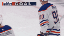 a hockey player with the number 90 on his jersey stands on the ice