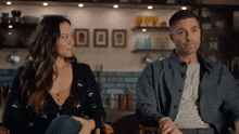 a man and a woman sitting next to each other