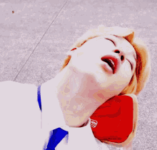 a man laying down with his mouth open in a blue tie