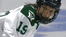 a hockey player wearing a helmet and a jersey with the number 19 on it