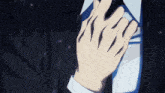 a man in a suit and tie is adjusting his tie in the rain