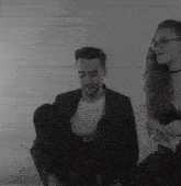 a man and a woman are sitting next to each other