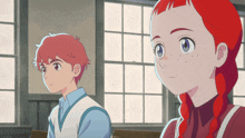 a boy and a girl with red hair are sitting next to each other in front of a window