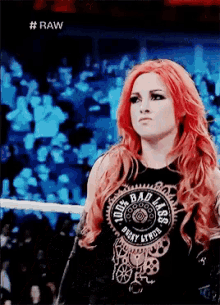 a woman with red hair is wearing a black shirt that says " 100 % bad ass "