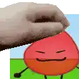 a hand is touching a red cartoon character with its tongue out .