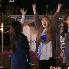 a girl with the number s1 on her shirt is cheering