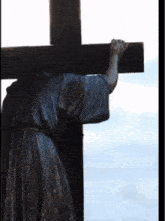 a statue of a man carrying a cross