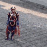 a person in a superhero costume stands on a sidewalk