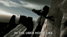 a man is climbing up a rock wall with the words in the uber home like below him .