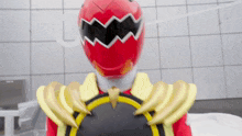 a red and yellow power ranger with bananas on his armor