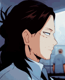 a close up of a man 's face with a bun in his hair
