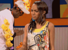 a man in a chef 's hat stands next to a girl in a tank top
