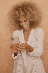 a woman with blonde curly hair is smiling with the words level up your style with hairfactory blonde wigs underneath her