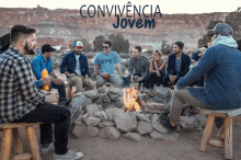 a group of people sitting around a campfire with the words convivencia jovem written above them