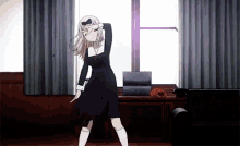 a girl is dancing in front of a window in a room .