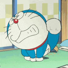 a cartoon of doraemon sitting on the floor with his eyes closed