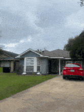 a red car is parked in front of a house with a texas license plate