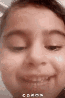 a close up of a little girl making a funny face with her eyes closed .