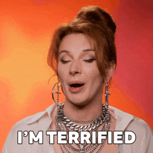 a woman with a bun says i 'm terrified with her mouth open