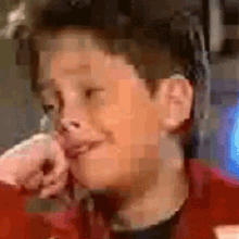 a blurry picture of a man 's face with a red shirt on