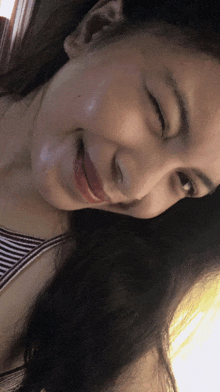 a close up of a woman 's face with her eyes closed and her mouth open