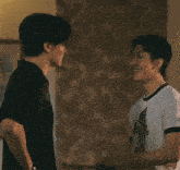 a man wearing a watch is hugging another man in a white shirt