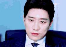 a close up of a man 's face with kbs2 written in the corner