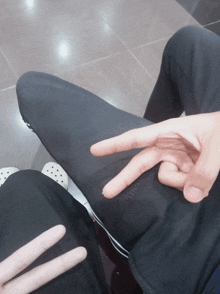 a person making a peace sign with their hands