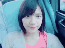 a woman with short hair is sitting in a blue chair