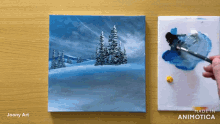 a painting of a snowy landscape is being painted by joony art