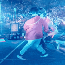 a man and a little boy are dancing on a stage .