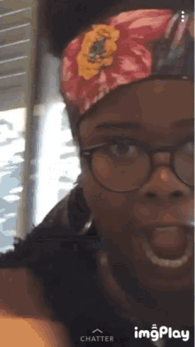 a woman wearing glasses and a headband with the word chatter on the bottom left