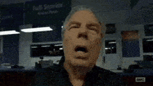 a man is yawning in front of a sign that says full service order here
