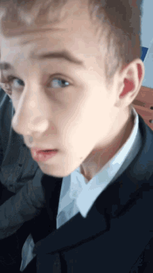 a close up of a young man 's face with his mouth open