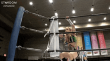 a woman in a wrestling ring with a stardom logo in the corner