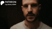 a close up of a man 's face with the words " patreon cap bailey asmr " behind him