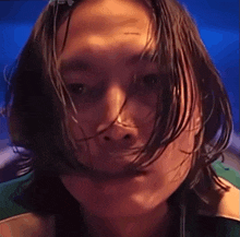 a close up of a person 's face with long hair .