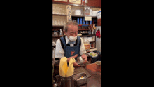a man wearing a mask is standing in a restaurant holding a glass .
