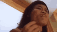 a close up of a woman 's face with her mouth open and her eyes closed .