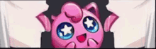 a pink pokemon with blue eyes and a star on its head is being held by a person .