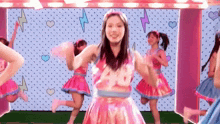 a girl in a pink dress with the number 28 on it