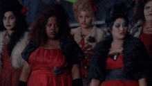 a group of women dressed up as zombies are sitting in a room