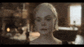 a woman with blonde hair is looking at the camera