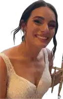 a woman in a wedding dress is smiling and holding a chair