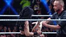 a woman in a wrestling ring with a belt that says ' intercontinental ' on it