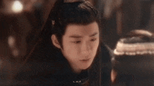 a close up of a young man wearing a traditional costume .