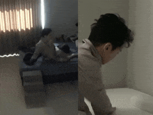 a man laying on a bed next to a window and another man sitting on a bed