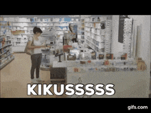 a woman is standing in a pharmacy with the words kikussss written on the counter